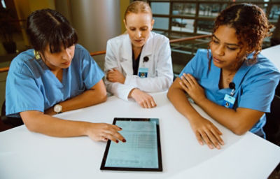 Healthcare professionals reviewing post-event data on Stryker's CODE-STAT data review software