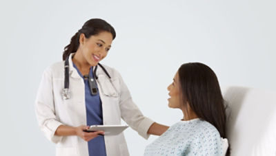 Nurse wearing Sync Badge interpreting for patient