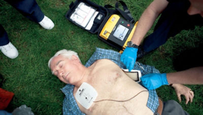 Man lying on ground with the LIFEPAK 1000 defibrillator attached to his chest