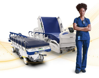Nurse standing with arms crossed in front of hospital beds