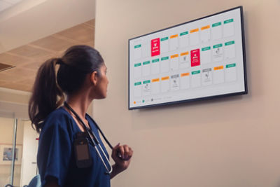 Nurse looking at monitor on wall 