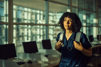 Nurse walking wearing backpack 