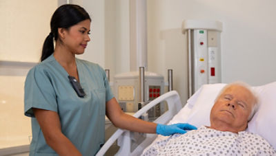 nurse wearing sync badge bedside with patient