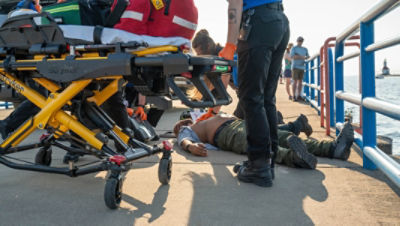 EMS responding to an unconscious patient with a cardiac emergency on a pier with the Power-PRO 2
