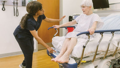 nurse assisting patient getting out of prime connect stretcher