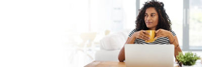 Women sitting at a desk drinking coffee