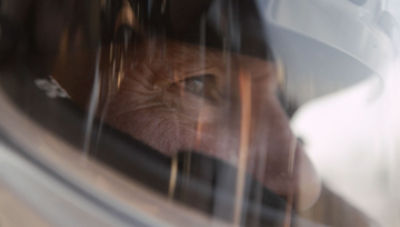 Scott Vanacore inside car wearing racing helmet