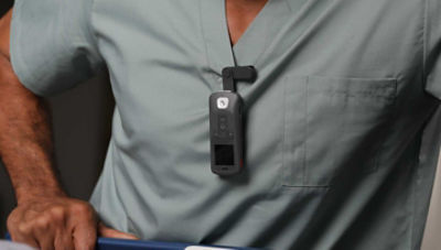 Nurse in scrubs wearing the Sync Badge