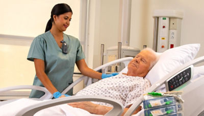 Nurse wearing Sync Badge standing next to patient
