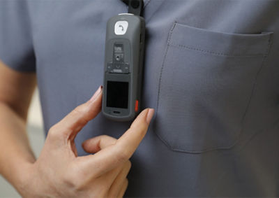 Nurse pressing Sync Badge panic button