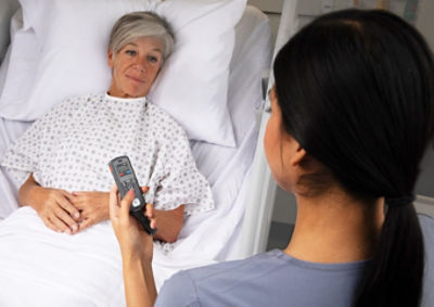 View of Sync Badge over nurse shoulder with patient in background