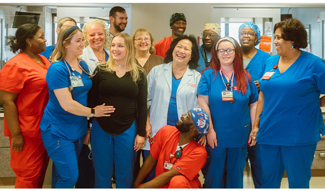 nurses and patient posing for photo