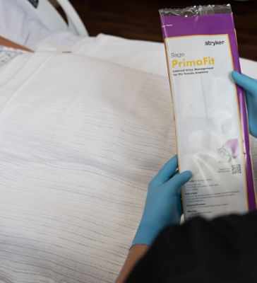 Nurse holding PrimaFit External Urine Management Device for the Female Anatomy