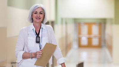 school administrator wearing smartbadge and holding clipboard