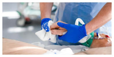Nurse wiping a patient's fingernails clean with a cloth