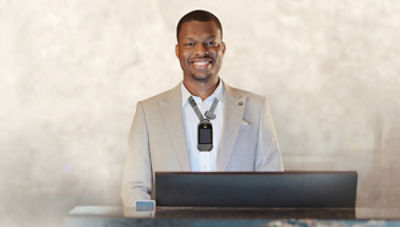 Hotel staff member wearing Vocera Smartbadge