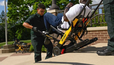 A patient being transported down stairs using the Xpedition powered stair chair