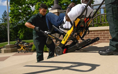 A patient being transported down stairs using the Xpedition powered stair chair